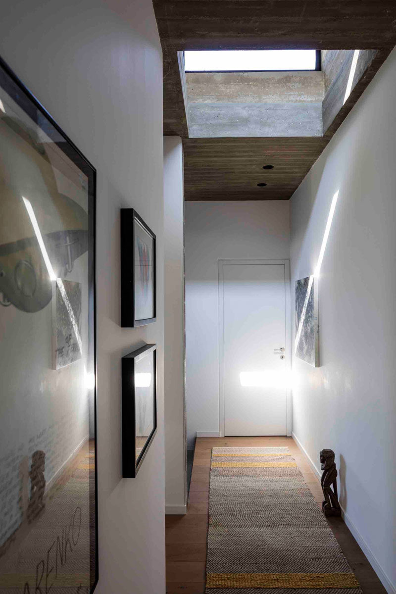 This hallway is kept bright by the use of a skylight that fills the area with natural light, and like the smaller windows in the living area, provides a glimpse of the sky.