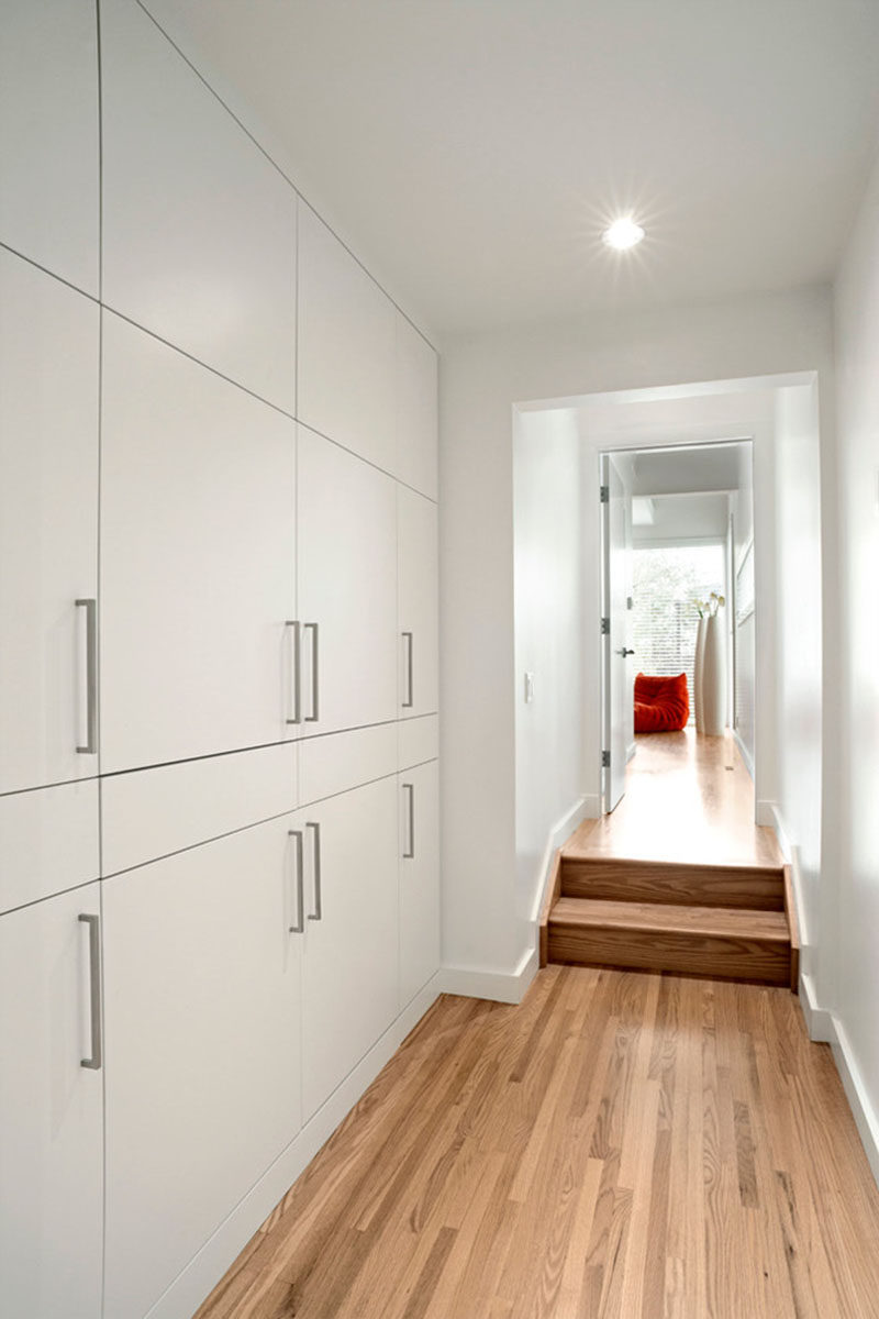 If you want to include a laundry in your home but are short on space, think about hiding the laundry room within closets. This laundry hidden within a wall of hallway closets features a washer and dryer as well as pull-out folding tables and an ironing board.