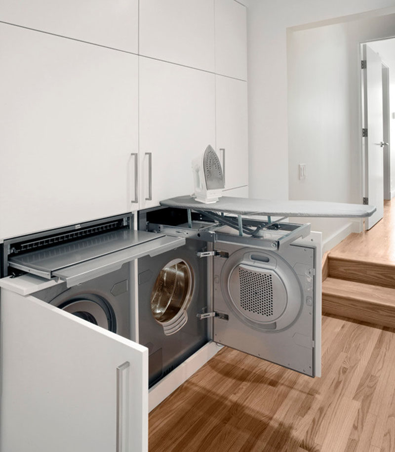 If you want to include a laundry in your home but are short on space, think about hiding the laundry room within closets. This laundry hidden within a wall of hallway closets features a washer and dryer as well as pull-out folding tables and an ironing board.