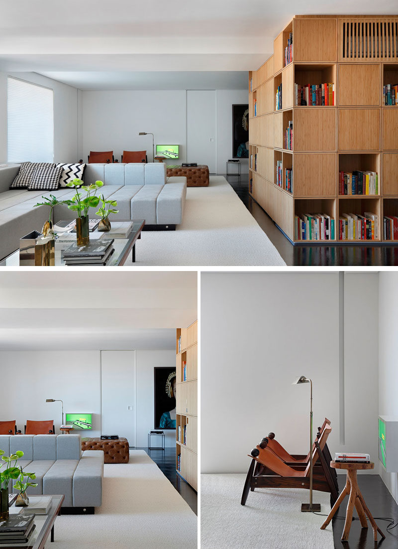 This modern living room has a double-sided couch to allow for tv watching on one side, and a more formal sitting area on the other.