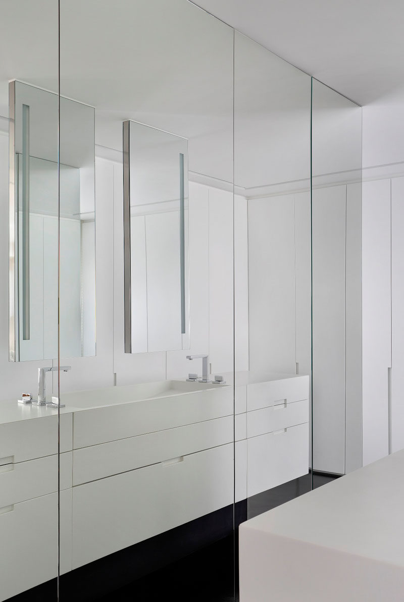 Full floor-to-ceiling mirrors cover these closets in this modern bathroom and allow you to check your outfit from every angle before stepping out.