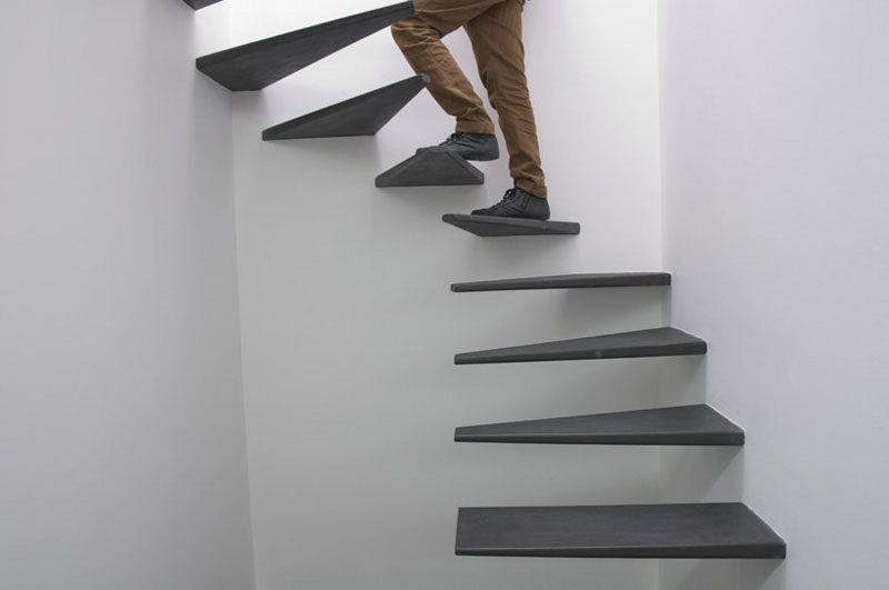 These floating black stairs were custom designed for this home and are a creative alternative to a spiral staircase.