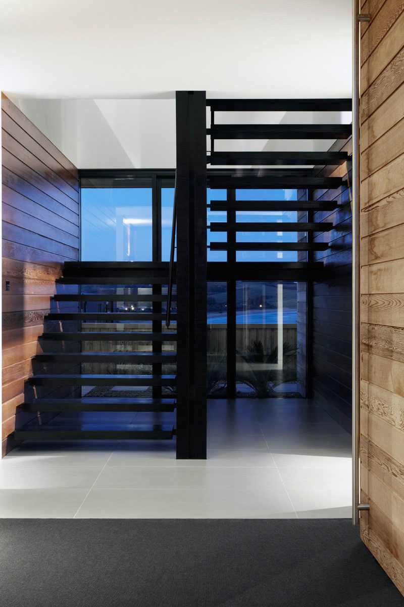 The openings between each step on these black stairs keep the entryway bright and let you take in the views as soon as you step in the door.