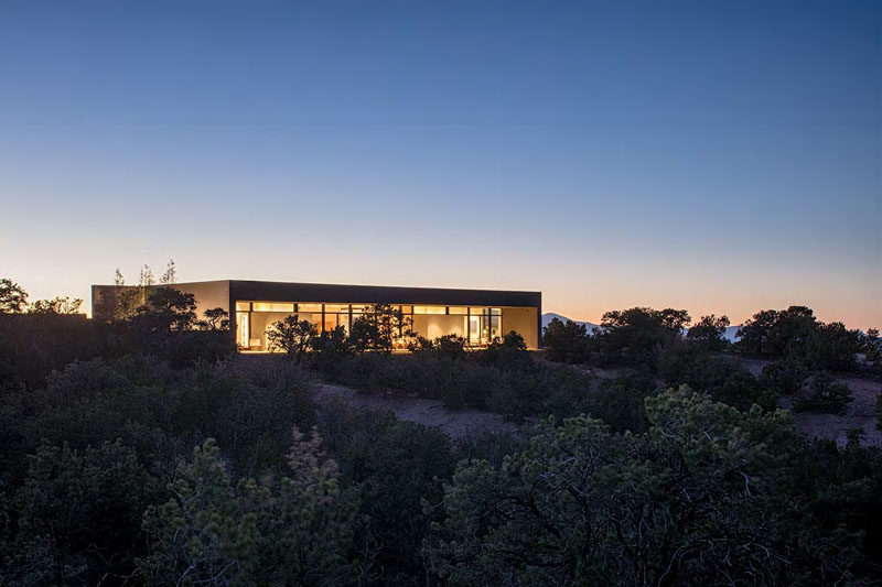 Specht Architects have recently completed this modern home in Santa Fe, New Mexico, that's organised around two perpendicular board-formed concrete walls.