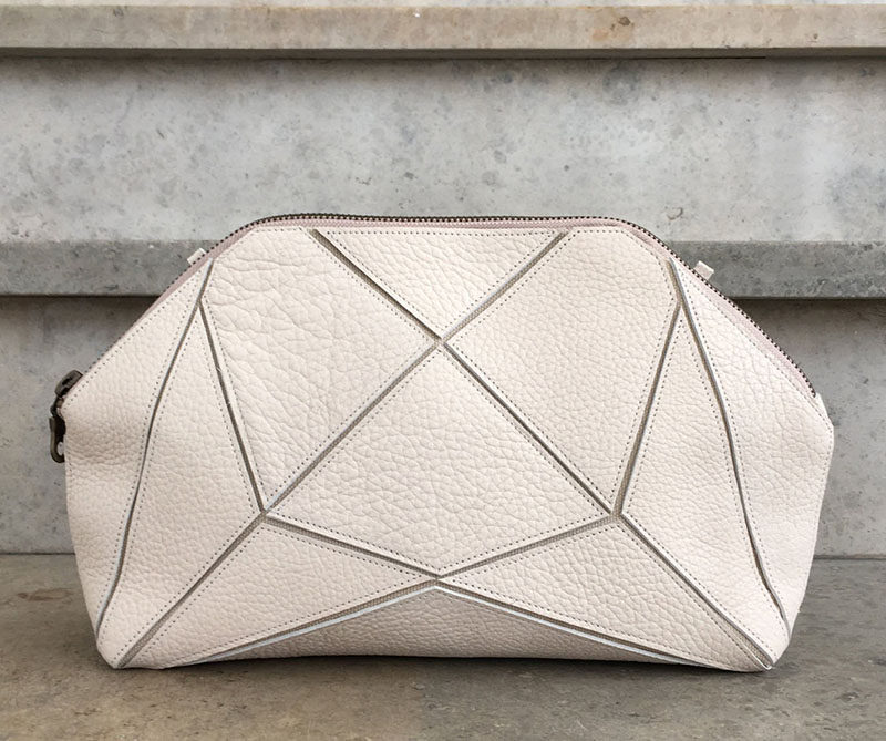 The Fold It! XXL Clutch with its geometric design, can be configured in multiple ways, including a clutch, a cross body bag and a toiletry bag. The shapes also allow the bag to be folded down completely to make it easy to pack with you in a suitcase.