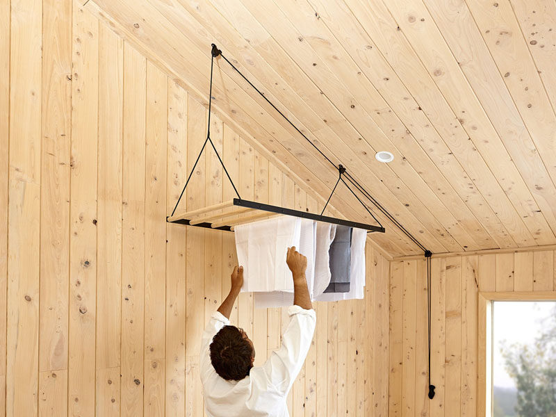 New Zealand based design firm George and Willy have created a modern hanging clothes drying rack that drops from the ceiling on a pulley system to dry and air your clothes.