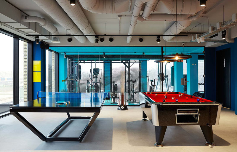 In this modern hotel, the games room has ping pong tables and a large pool table. Large floor-to-ceiling windows provide views of the city and fill the room with natural light.