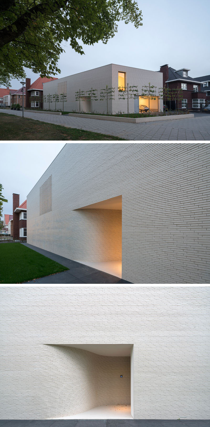 The exterior of this modern house is made up of white bricks with minimal windows. The entrance to the home is tucked away within a small alcove.