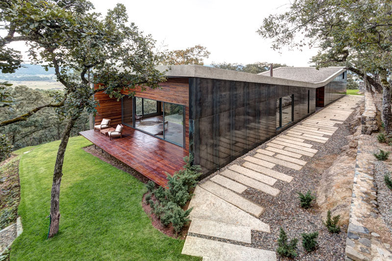 Elías Rizo Arquitectos have designed this modern house covered in steel, concrete and wood, for a middle-aged bachelor who wanted to build a weekend house in the forest.