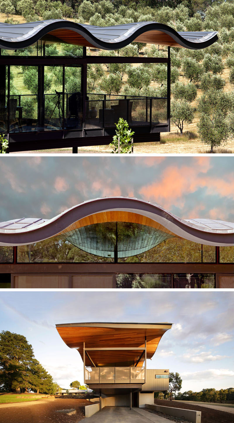 This modern house in Australia features a sculptural and wavy roof made from metal and wood, that's been designed to mimic the rolling hills surrounding the home.