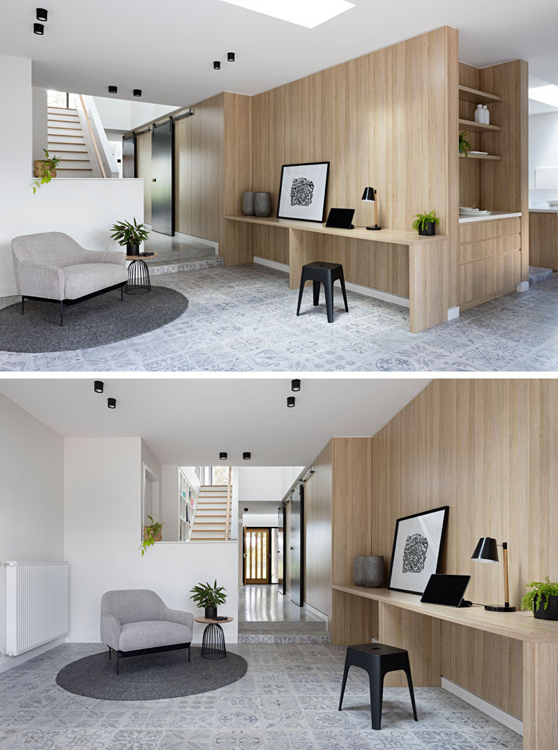 In this modern rec room (also known as a rumpus room in Australia), slim built-in desks line the wall of a central pod, while a light grey decorative tile covers the floor.
