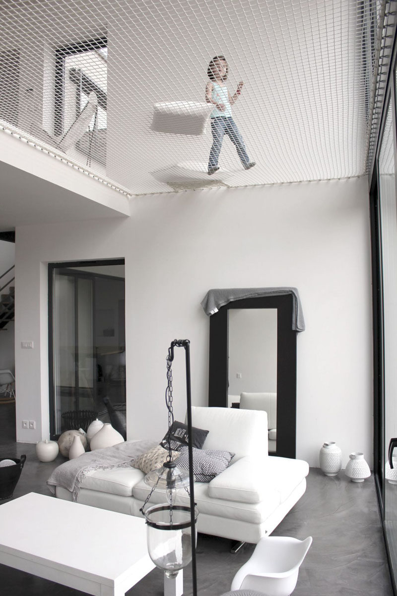 The net above the living room in this modern home creates a play space for kids, and a relaxing spot for grownups.