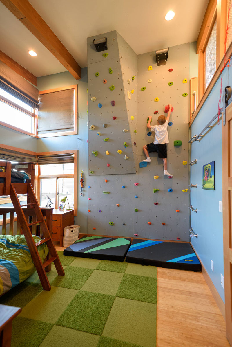 This rock climbing wall in a kids bedroom has a couple of angles in it to give you the option of increasing the challenge of the climb when one route starts to get too easy. #RockClimbingWall #InteriorRockClimbingWalls #InteriorDesign