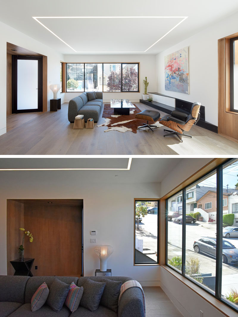 Just inside the entrance of this modern house is the living room that overlooking the street at the front of the house, and is defined by the built-in lighting in the ceiling.