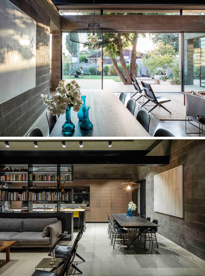 This modern dining room shares the space with the living room, and a single sculptural pendant light anchors the dining table and chairs.