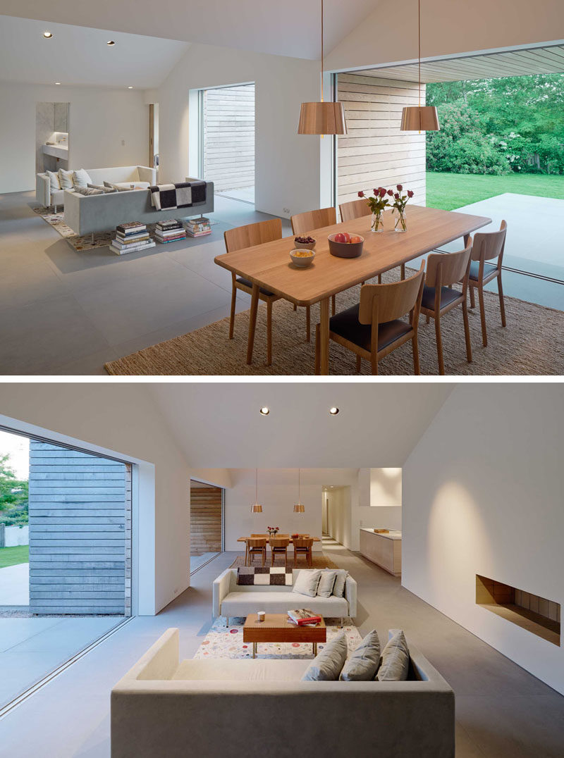 Inside this modern house, the living room and dining room share the same space, however each part of the room opens up to the outdoors.