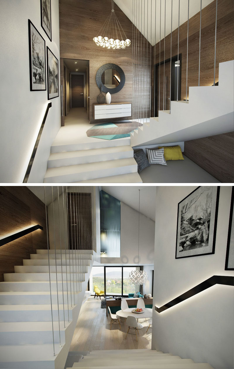 These modern white stairs surrounded by wood walls feature backlit handrails that make sure that you can see where you are going, even when it's dark.