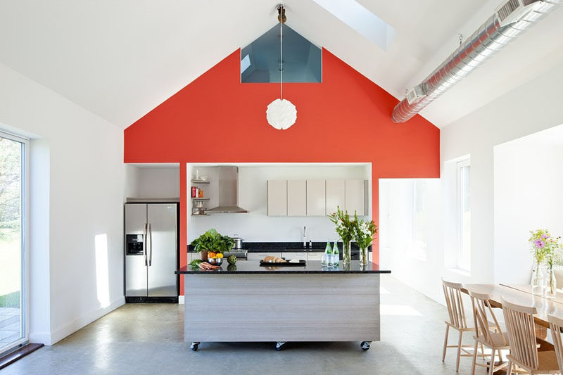 This movable kitchen island in this bright and modern kitchen, can either be left in the middle of the kitchen or pushed off to the side to make room a large gathering or a family dinner.