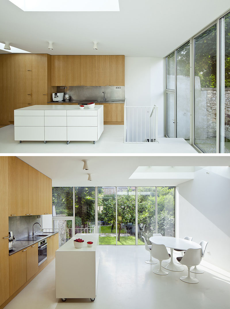 This large, modern, white, movable kitchen island can be used as extra prep space right in the kitchen or be pushed up against the wall to create a sideboard perfect for serving multiple people.