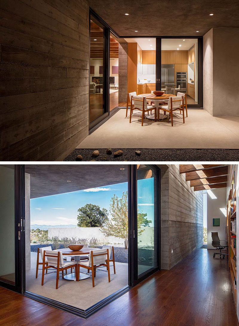 Just off the kitchen in this modern house is a covered outdoor dining area that's accessed through two sliding doors that open on the corner. 