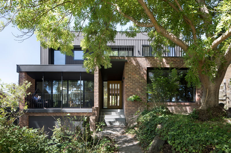 Inbetween Architecture have designed the modern renovation of a 1970's double storey brown brick house near a park in Melbourne, Australia, that's home to a family of 5 that have outgrown the home.