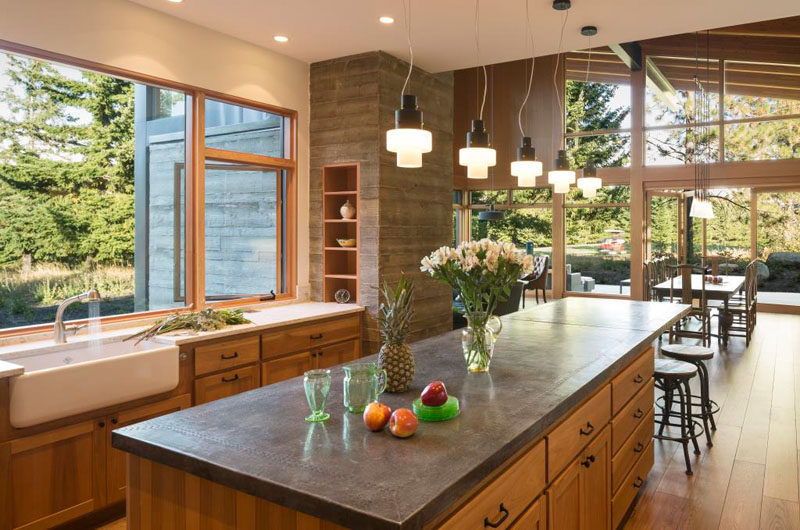 Inside this modern cabin, there's a rustic modern kitchen with a large farmhouse sink, while lots of work surfaces provide ample space for preparing family meals.