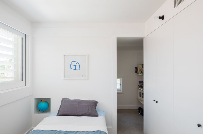 In this small bedroom there's lots of storage space in the form of large cabinets and a walk-in closet with more storage for clothes and toys.