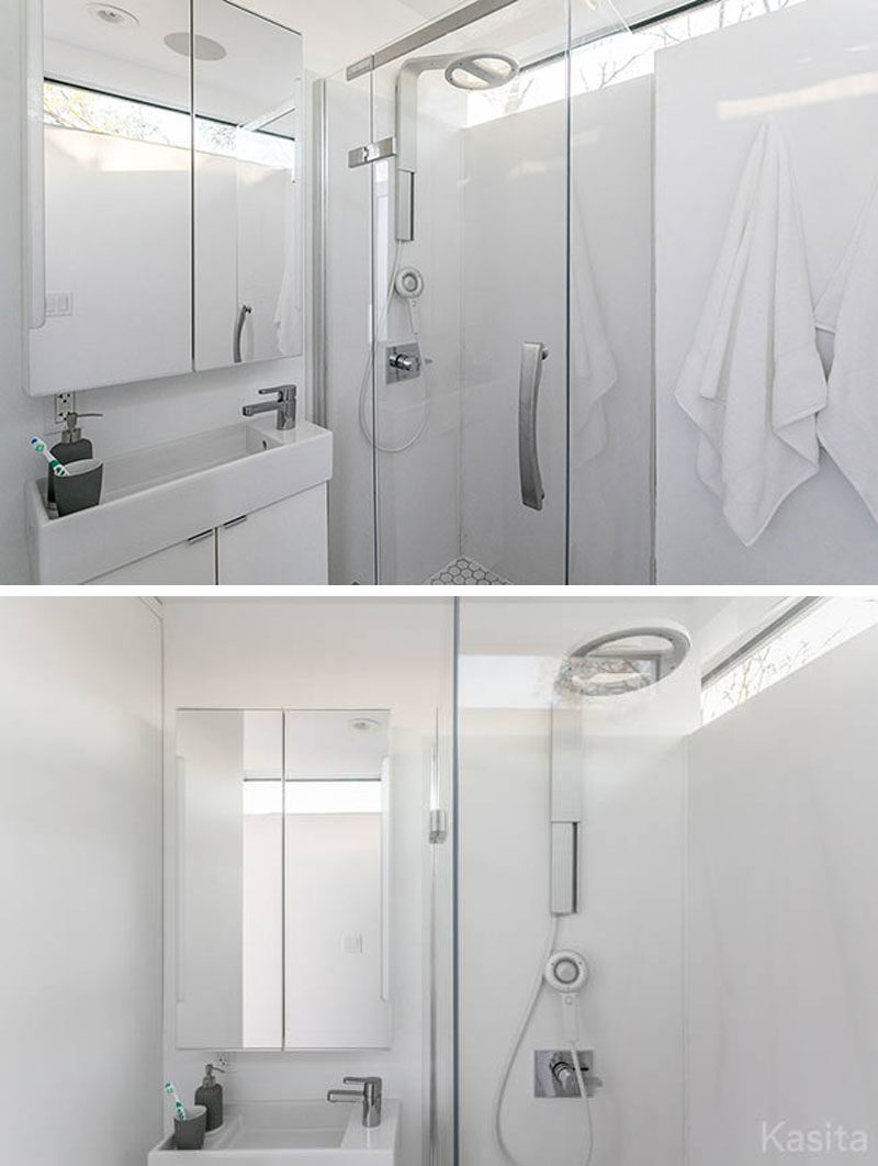 In this modern tiny home is a small bathroom with a shower, toilet and vanity. #TinyHouse #TinyHome #Architecture #SmallLiving #ModernTinyHouse #SmallHouse #TinyBathroom