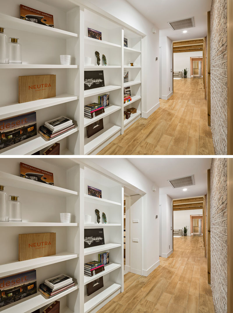 When this secret door is closed you wouldn't even know this built-in white bookshelf in a hallway hides a secret room.