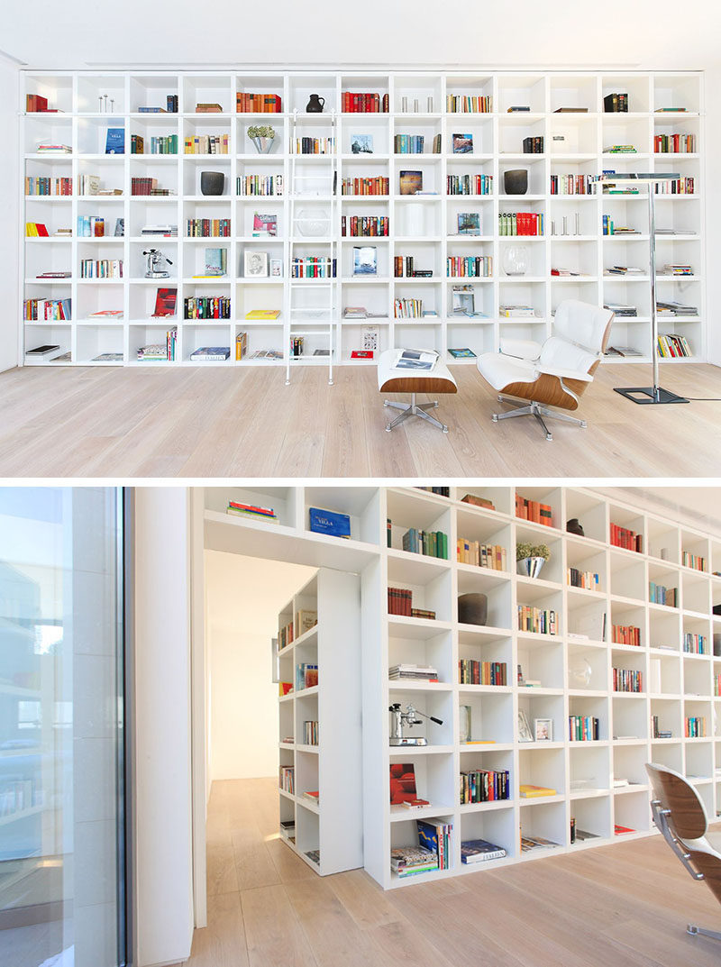  When it's closed, this secret door blends in completely with the other shelving units in this large wall of white bookshelves.