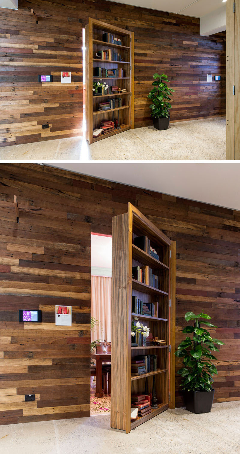 This wooden bookshelf door blends right into the wood paneled wall making it even less likely that you'd expect to find a hidden room behind it.