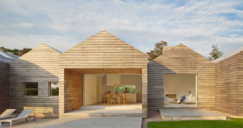 The design of this modern Swedish house, with its peaked roofs and horizontal wood plank siding, was inspired by the wood barns found in the surrounding area.