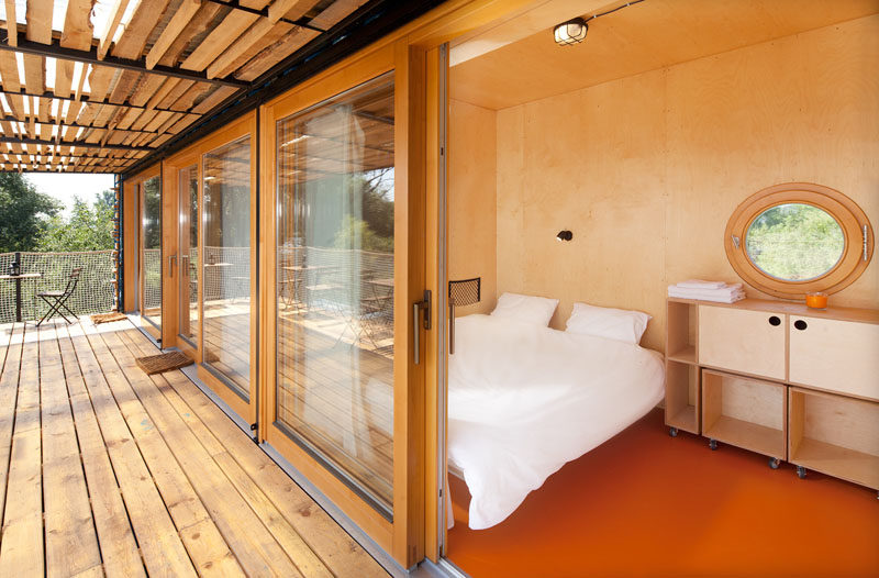 These rooms in a shipping container hotel have walls and ceilings made from plywood.