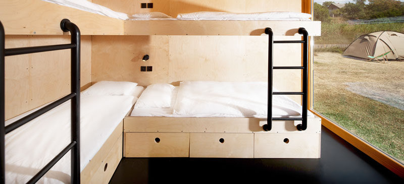In this boutique shipping container hotel, there's a room with custom plywood bunk beds for four people.