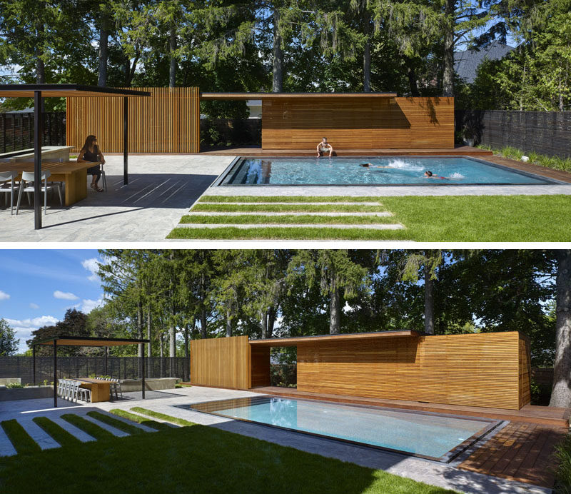 This modern landscaped backyard has a grassy lawn, a swimming pool, an outdoor kitchen with wood burning pizza oven, an outdoor dining space with trellis, a firepit, and a pool house with bathroom and change room.
