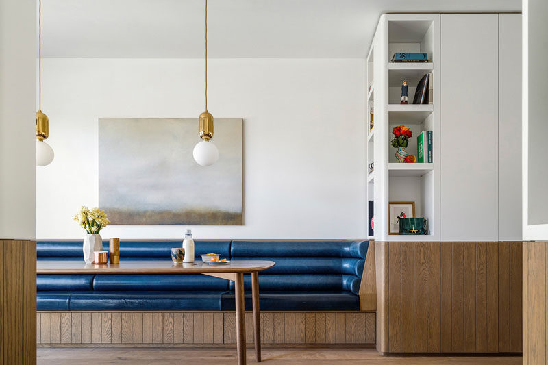 This dining area has a built-in banquette bench, inspired by Eileen Grey and her Bibendum Chair.