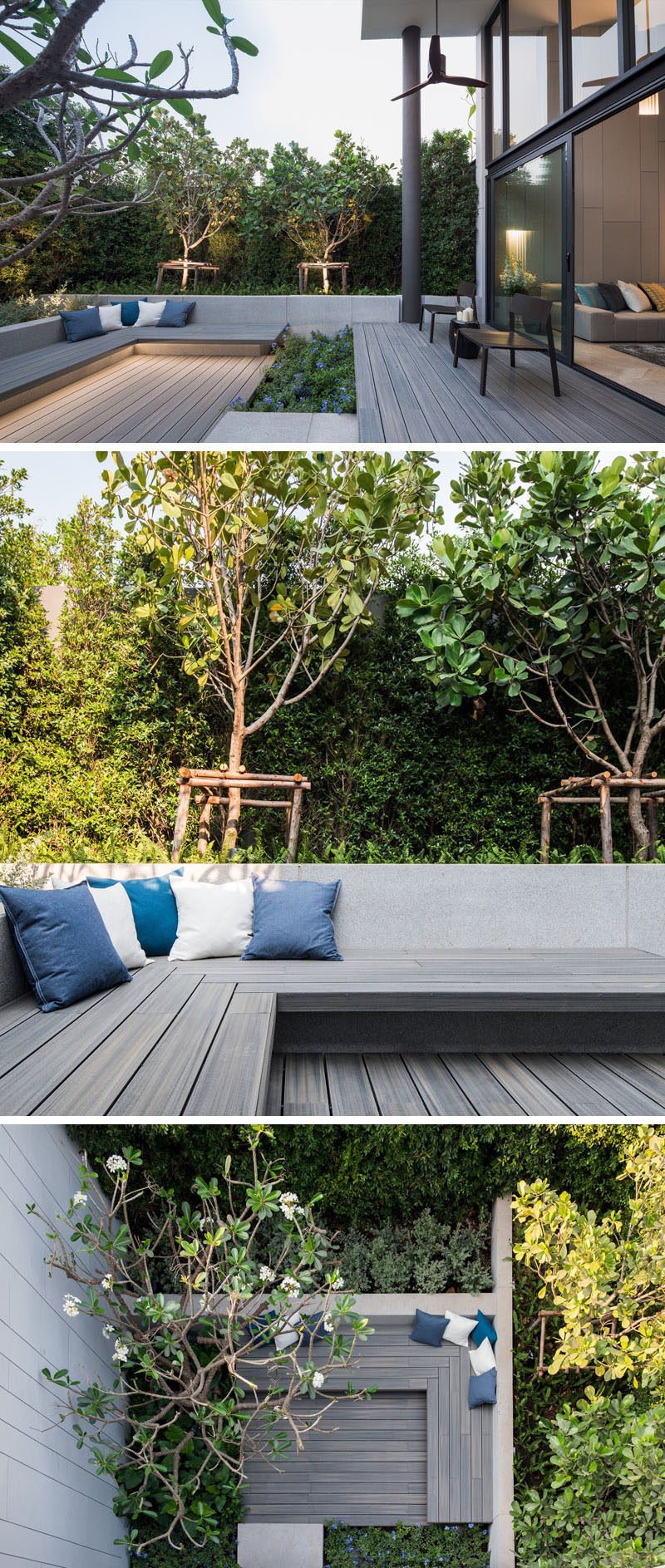 This small and modern backyard has a small path that connects the patio to a larger seating area with built-in wood benches and hidden lighting, that's surrounded by plants.