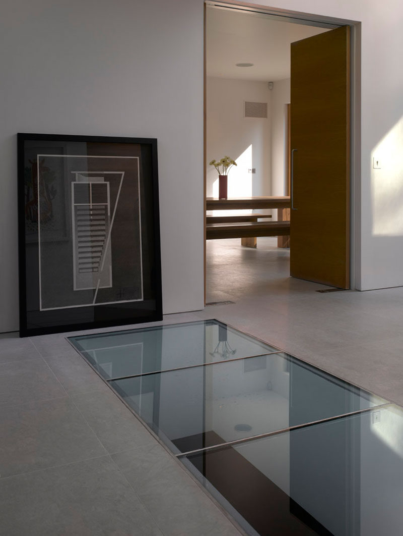 There's a glass panel or skylight in this floor that allows you to look down to the level below that's home to a pool.