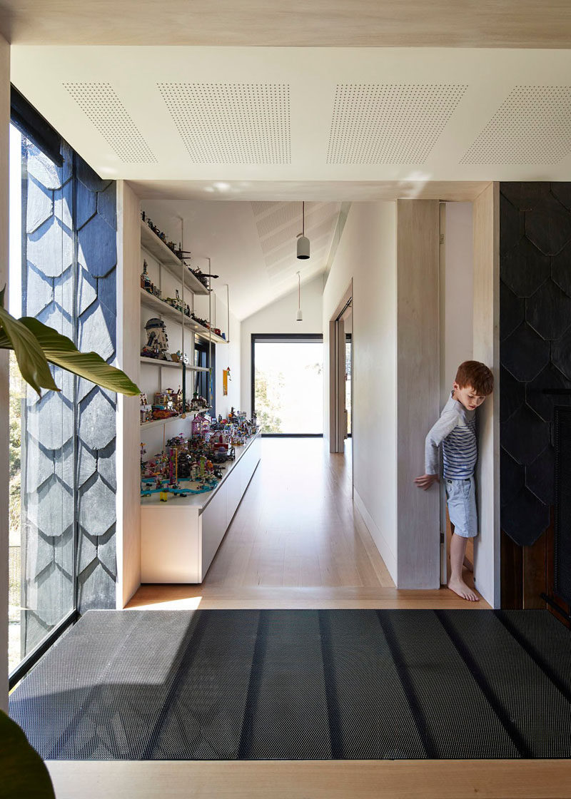 White open shelving and a cabinet provide plenty of space for displaying kids toys.