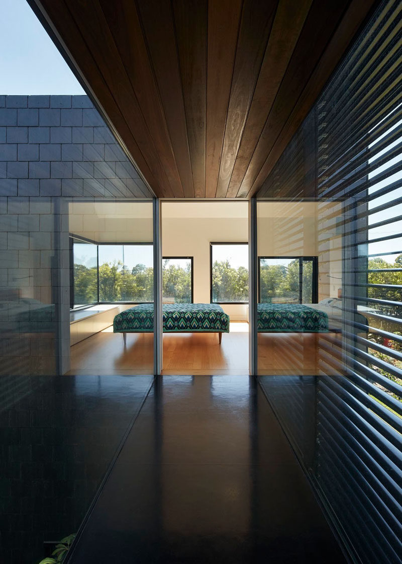 To reach the private master bedroom (or parent's room) in this modern house, there's a bridge that must be crossed, that also provides views of both sides of the home.