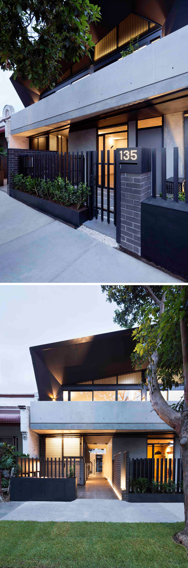 This modern apartment building has a black fence positioned behind planters that add a touch of greenery to the brick and concrete facade.
