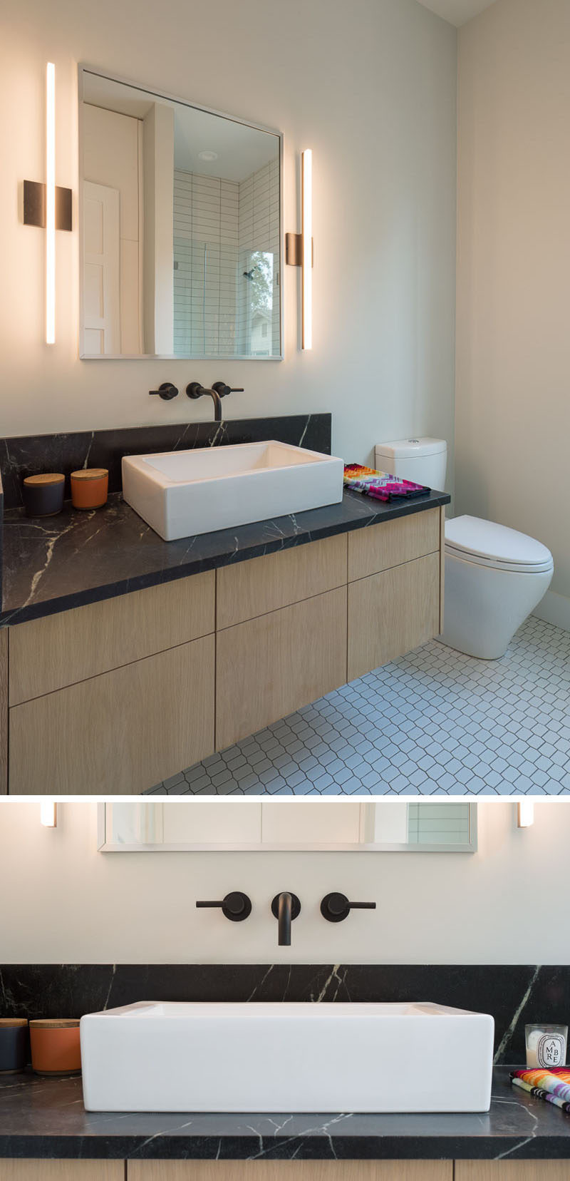 This modern bathroom features a floating vanity with a black countertop and sconces that flank the mirror.