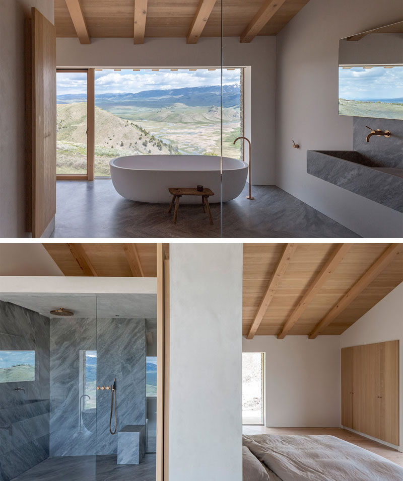 This master ensuite bathroom has a standalone white bathtub with a huge picture window so you can relax and take in the view. There's also a large walk-in shower gives you plenty of room to get clean.