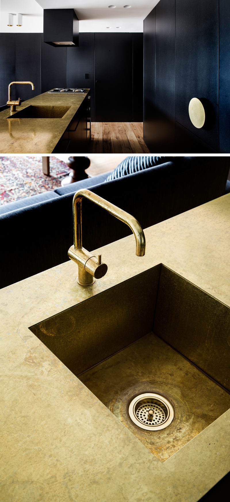 This modern and dramatic kitchen has matte black cabinets and a gold countertop