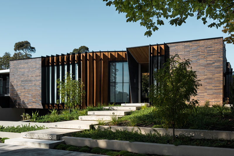 FIGR. Architecture & Design have designed this contemporary dark brick home in Australia, that wraps around a central courtyard.