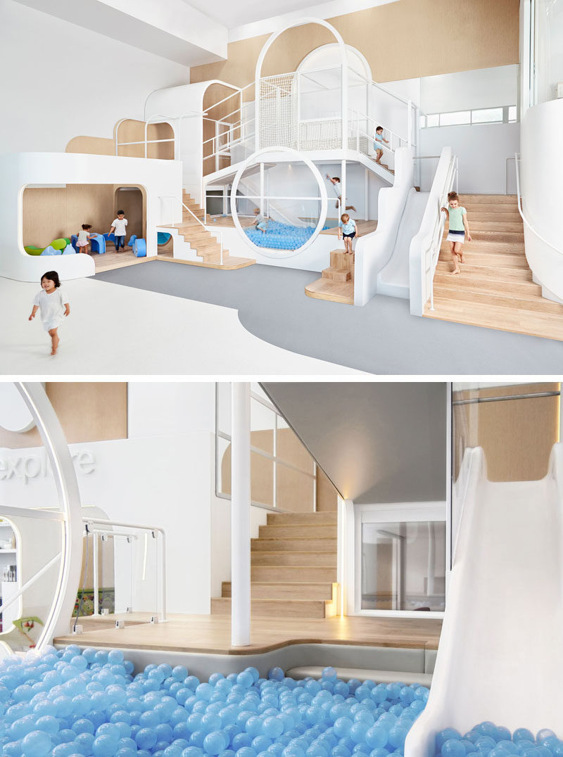 A simple color palette of wood, white, and blue (and a touch of grey) make up this fun space that includes a slide that ends in a ball pit, as well as stairs and small nooks, perfect for kids to play in.