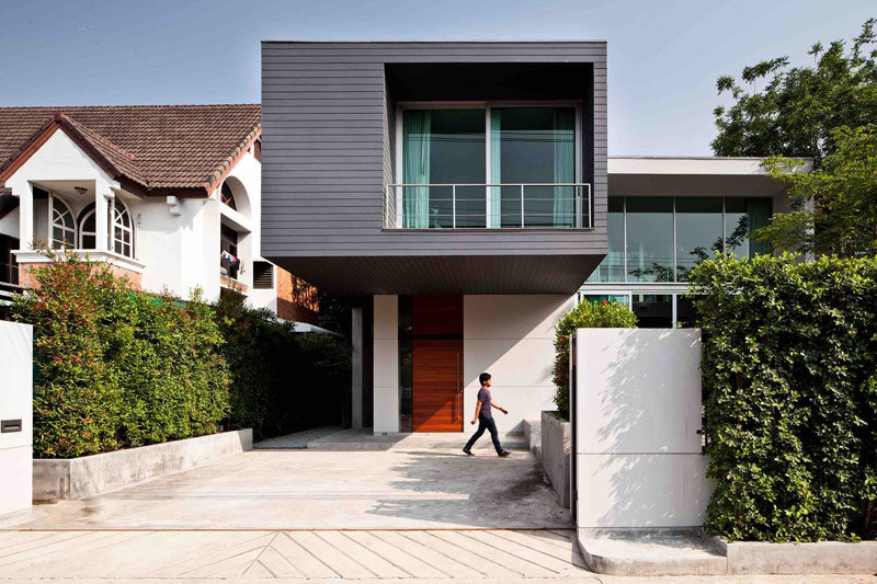 Lynk Architect have designed this two-storey house with a cantilevered bedroom in the outskirts of Bangkok, Thailand.
