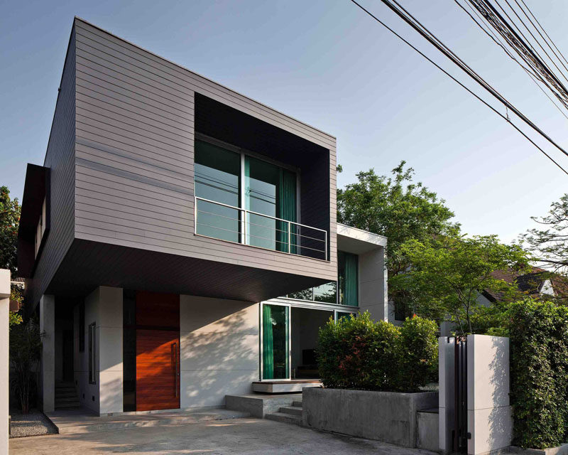 Lynk Architect have designed this two-storey house with a cantilevered bedroom in the outskirts of Bangkok, Thailand.