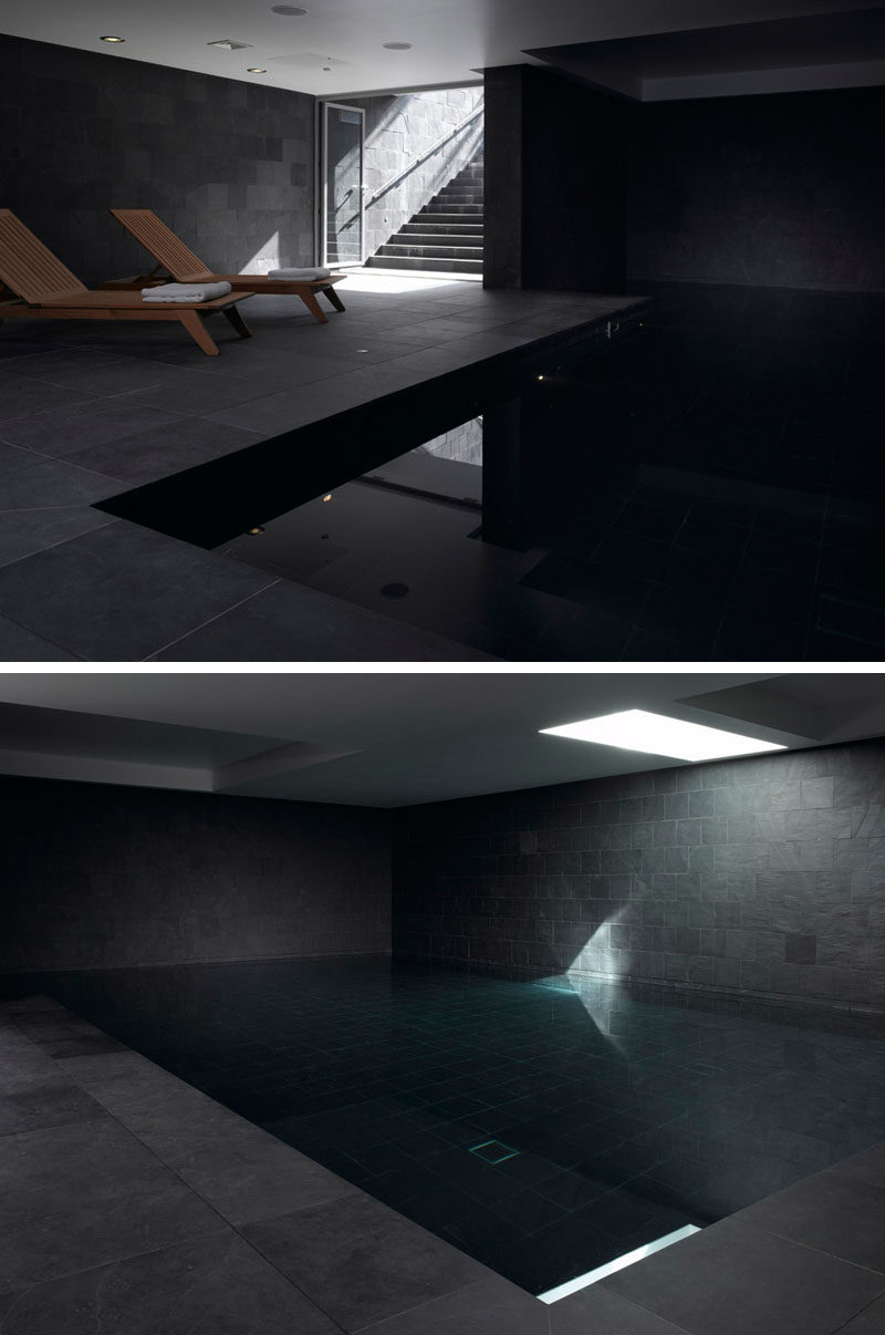 Hidden away in the lower level of this modern house is an indoor pool with dark grey slate tiles. 