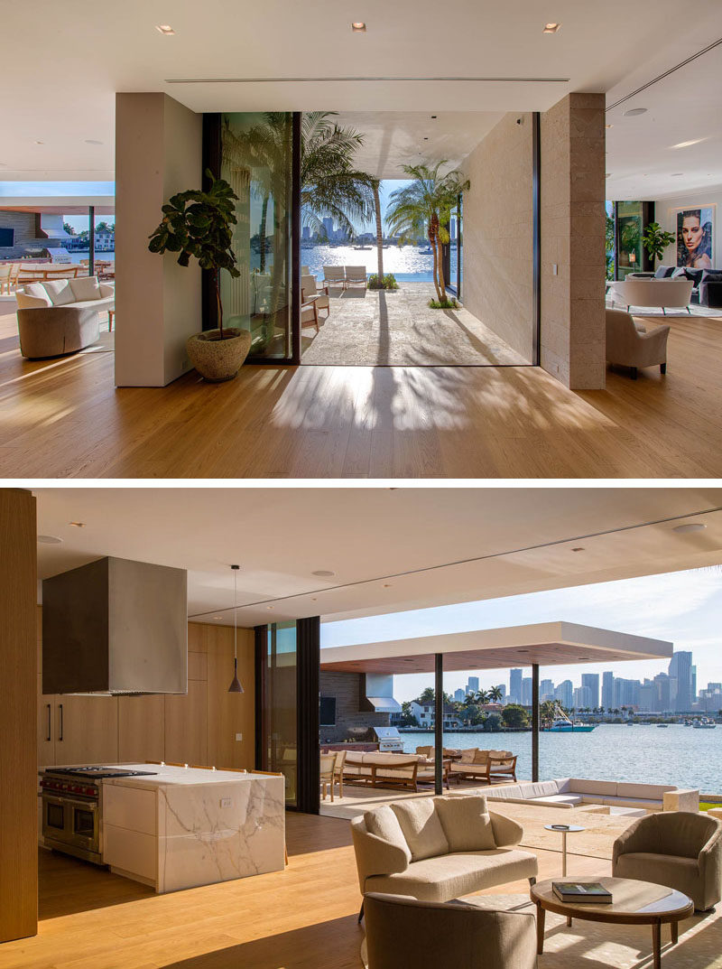 Inside the main floor of this modern house, the kitchen and a small sitting area are located to the left, while the living room is to the right